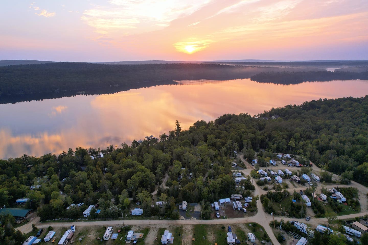 A view of the sunset over a lake from above.