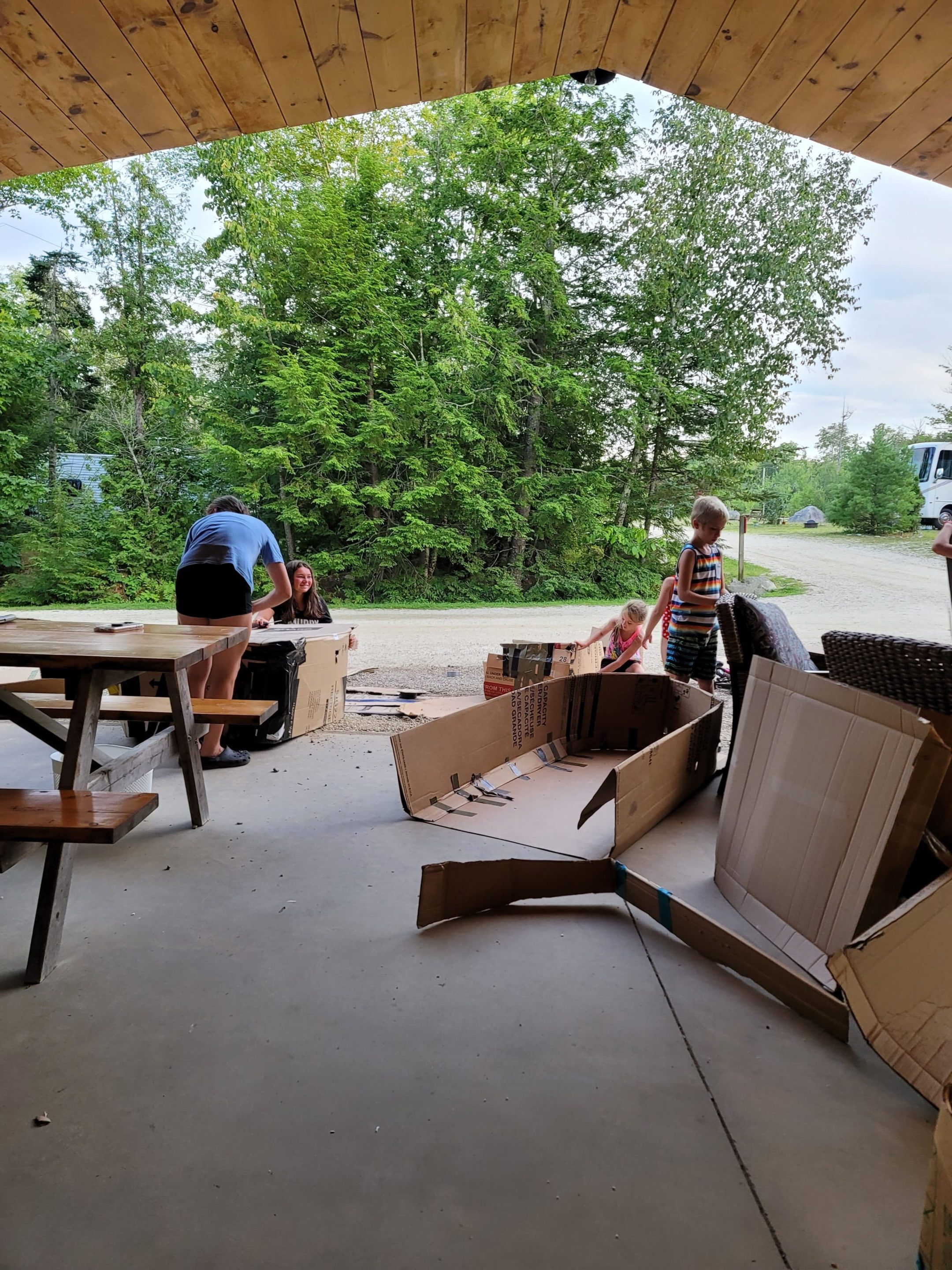 A group of people working on furniture outside.