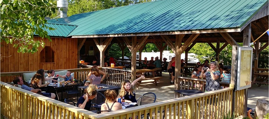 Outdoor dining area with people enjoying meals.