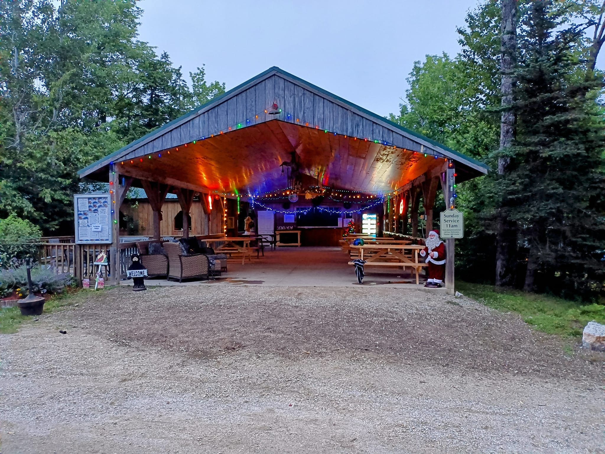 A large tent with lights and signs in the middle of it.