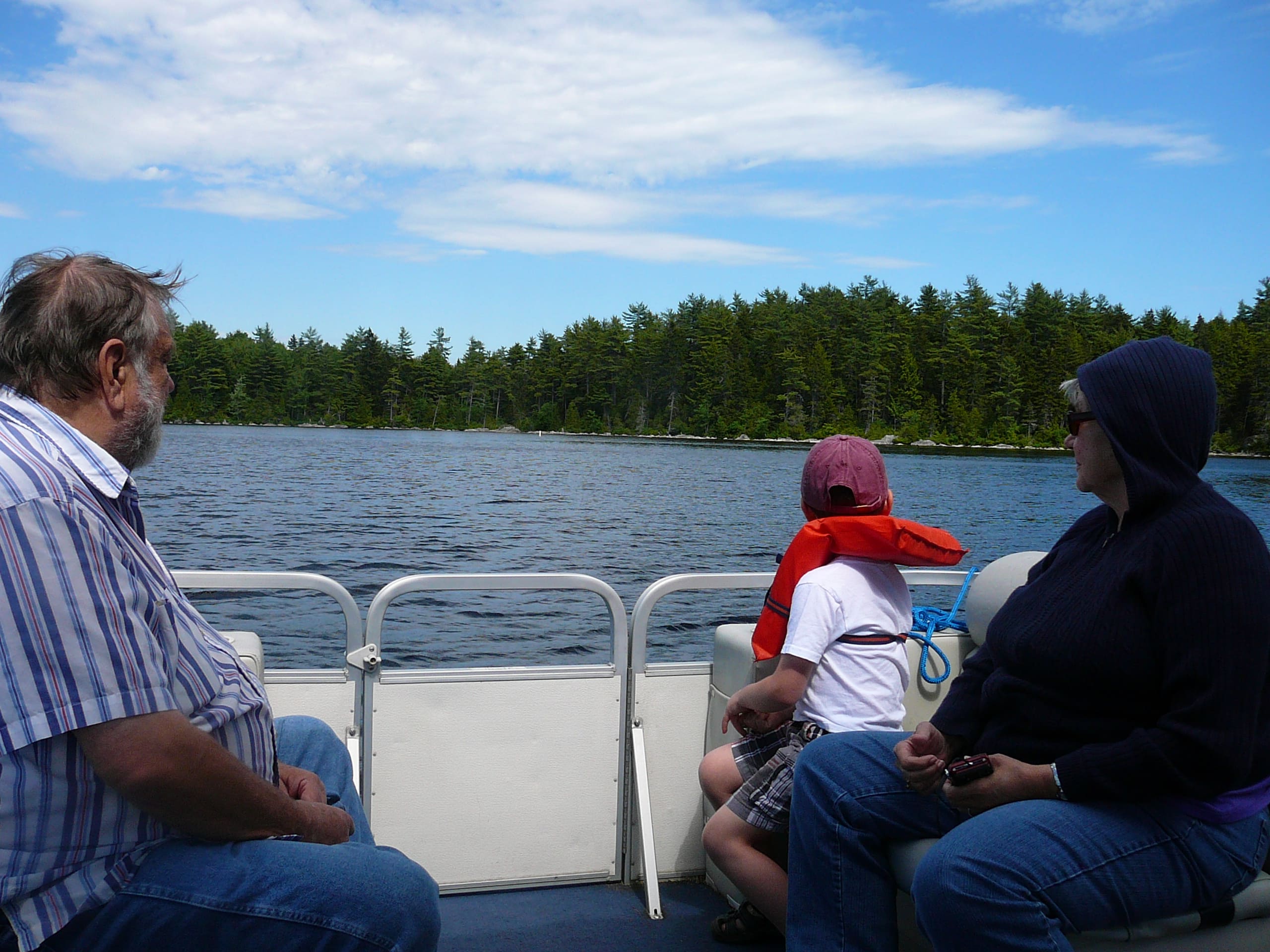 A group of people on a boat in the water.