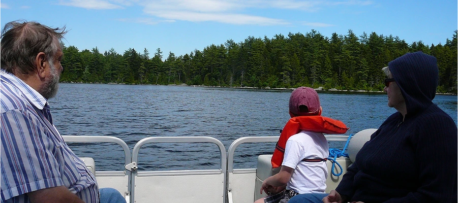 People on boat enjoying lake view.