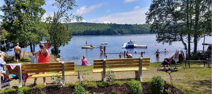 People enjoying a lake on a sunny day.
